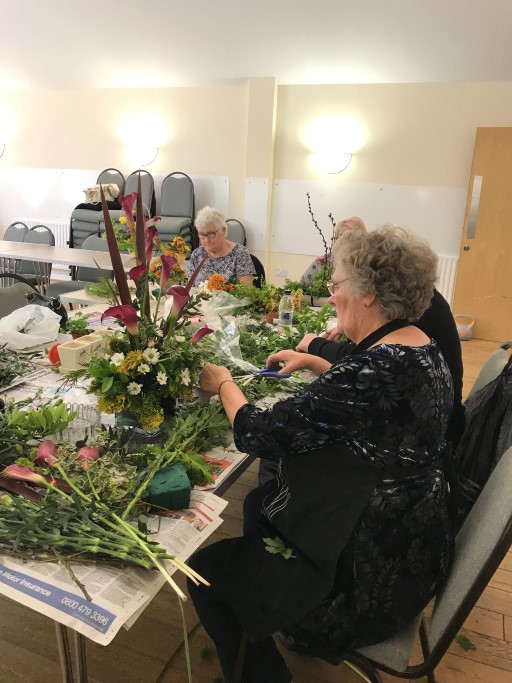 Members of Grey Matter Group making flower arrangements