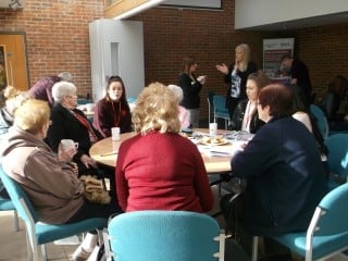 People sat chatting at the Remembrance Day coffee morning