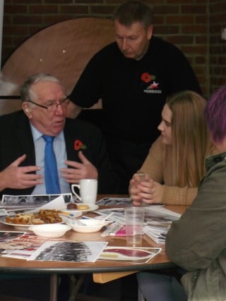 People sat chatting at remembrance day coffee morning