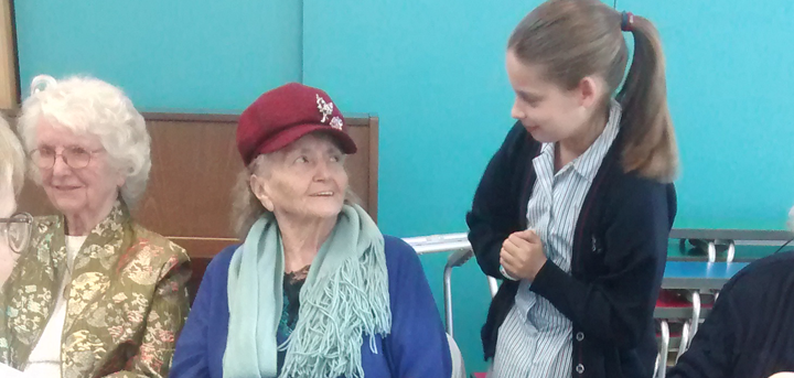 Day centre members with school pupil