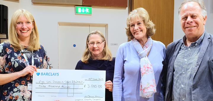Members of the Shropshire Charity Concerts Choir and Orchestra present a cheque to Catherine McCloy from Age UK SHropshire Telford & Wrekin