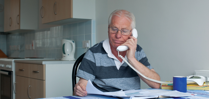 Older man reading paperwork