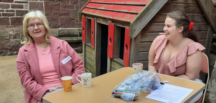 Dementia support group member and carer enjoying tea