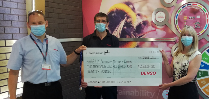 Denso staff presenting a cheque to our Head of Income Generation, Catherine McCloy