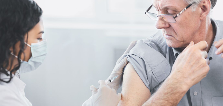 Older man being vaccinated