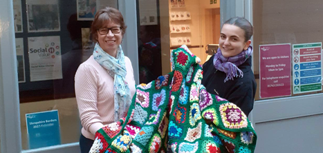 Emma Wilde and Rebecca Hughes with the blankets knitted by the Loppington Knitting Group