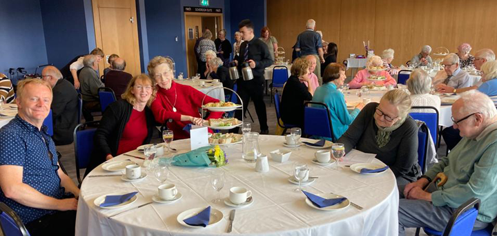 Older people enjoying afternoon tea at Montgomery Waters Meadow