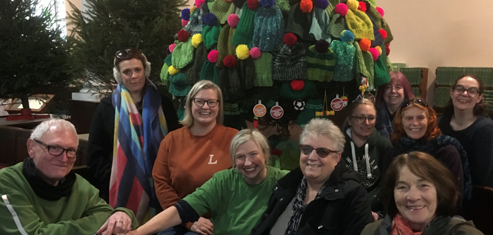 Castlefields Yarn Bombing Crew in front of their decorated Christmas tree