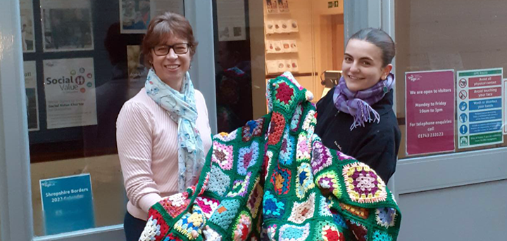 Emma Wilde and Rebecca Hughes with the blankets knitted by the Loppington Knitting Group