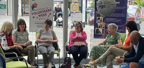 A group of people discussing volunteering in Age UK Shropshire Telford & Wrekin's Shrewsbury office
