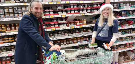 Dean Suter and Abi Bebb of R1 Construction shopping to fill gift boxes for local older people