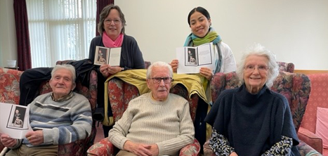 Members of Greenacres day centre with the card from King Charles III