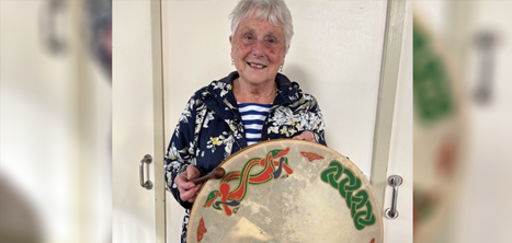 Barbara Evans holding the traditional Irish bodhran drum
