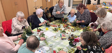 Women flower arranging at Age UK Shropshire Telford & Wrekin’s Woodside day centre