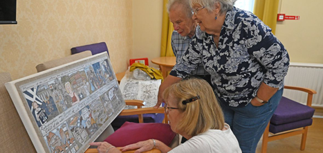 Day centre members looking at the artwork