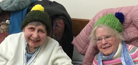 Two older women wearing knitted woolly hats