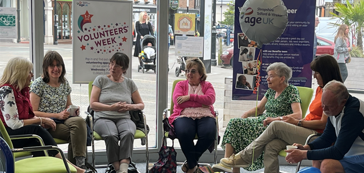 A group of people discussing volunteering in Age UK Shropshire Telford & Wrekin's Shrewsbury office