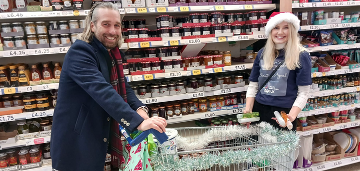 Dean Suter and Abi Bebb of R1 Construction shopping to fill gift boxes for local older people