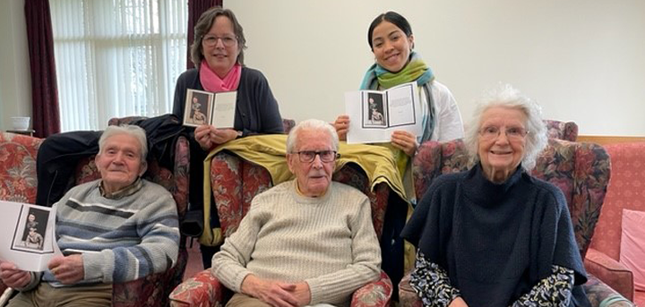 Members of Greenacres day centre with the card from King Charles III