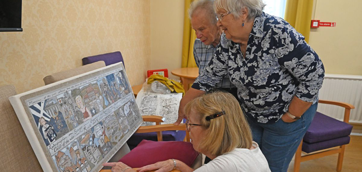 Day centre members looking at the artwork