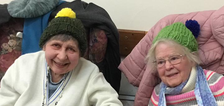 Two older women wearing knitted woolly hats