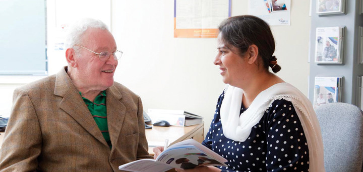 Woman helping older man with advice