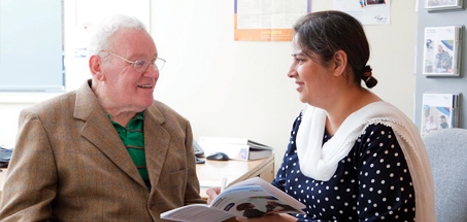 Woman helping older man with advice