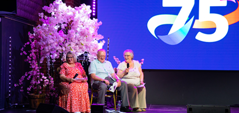 Three members of the Acorn Singers on stage