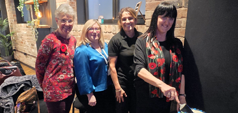 Anne Wignall cutting a cake at the Age UK Shropshire Telford & Wrekin AGM in November