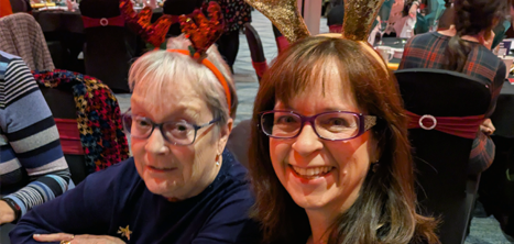 Two volunteers at the Christmas lunch event