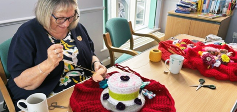 Woman creating a post box topper