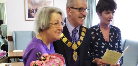 Ruth receiving flowers from the mayor