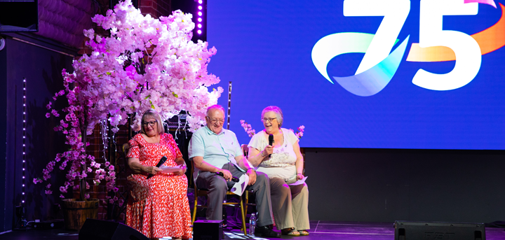 Three members of the Acorn Singers on stage