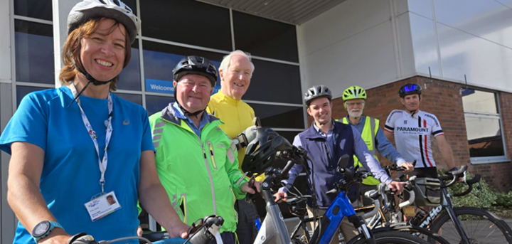 Group of cyclists outside a building