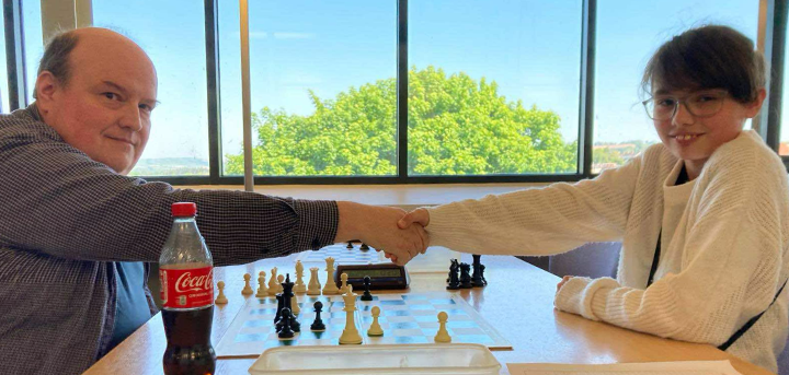 Two chess players meet at the intergenerational tournament at Ludlow Library