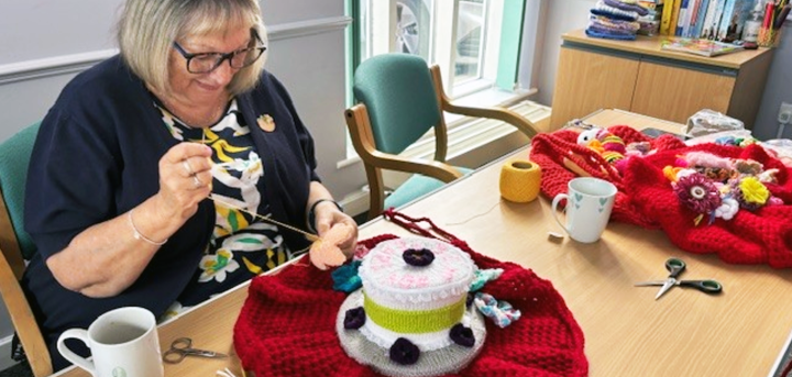 Woman creating a post box topper