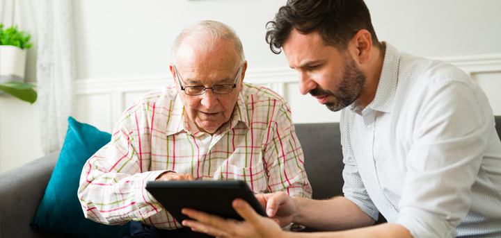 Two men looking at a computer table