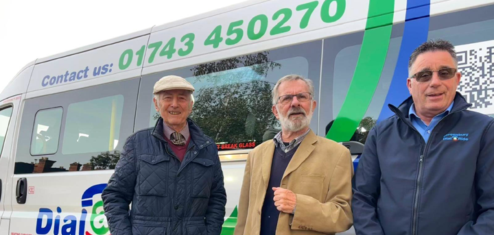 Three men standing by a Shrewsbury Dial-a-Ride bus