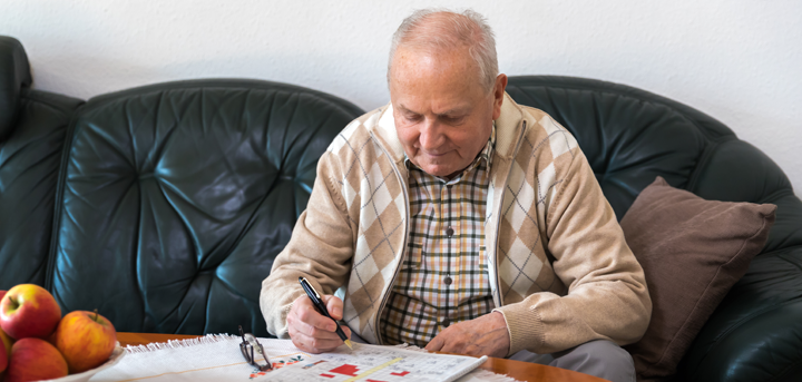 Older man doing crossword