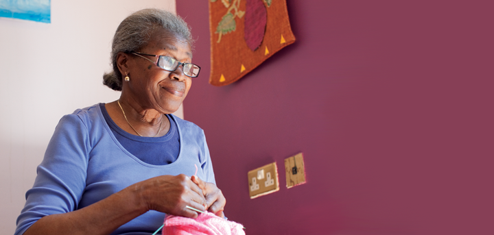 An older woman knitting