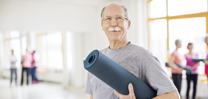 Older man with yoga mat