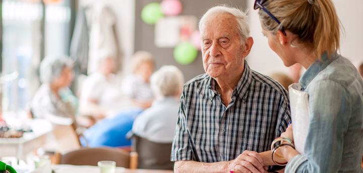 Older man with a volunteer at a day centre