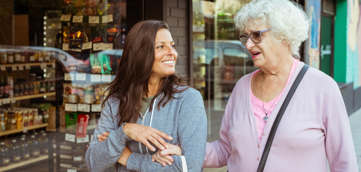 A befriending volunteer accompanying an older person on a shopping trip