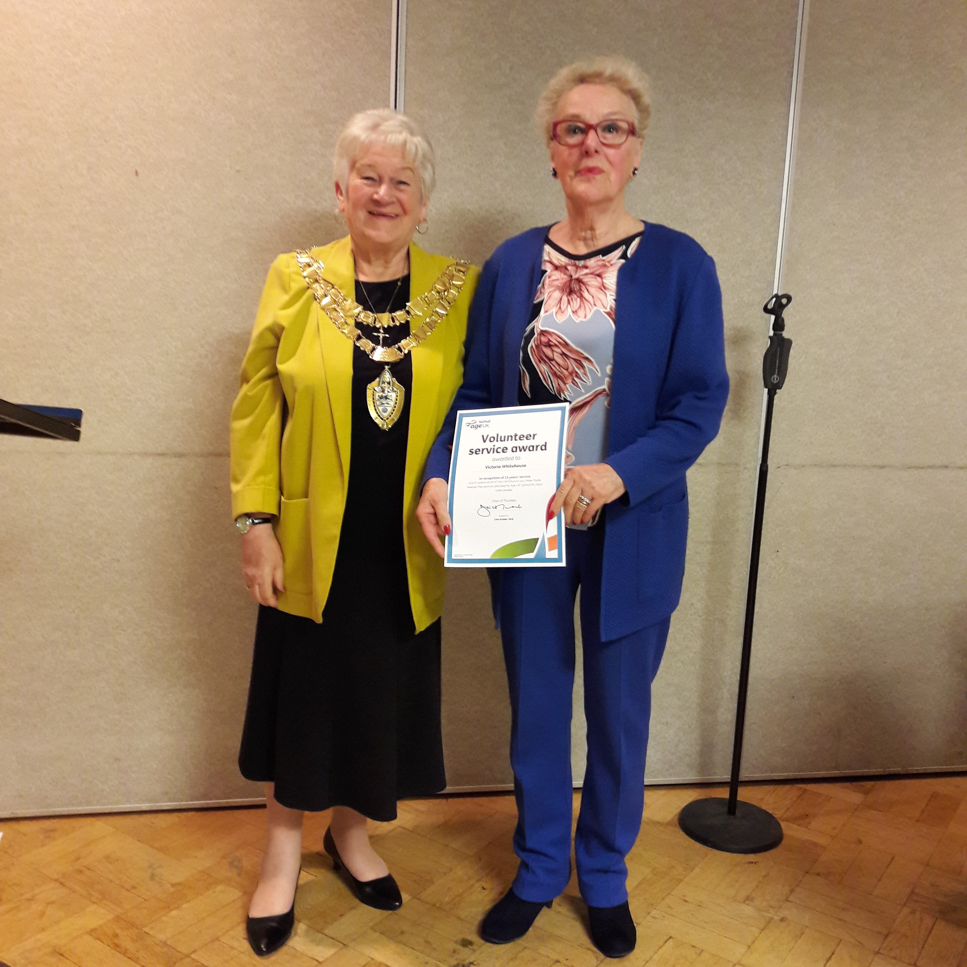 The Mayor of Solihull presenting Victoria with a certificate to mark 15 years of volunteering for Age UK Solihull.