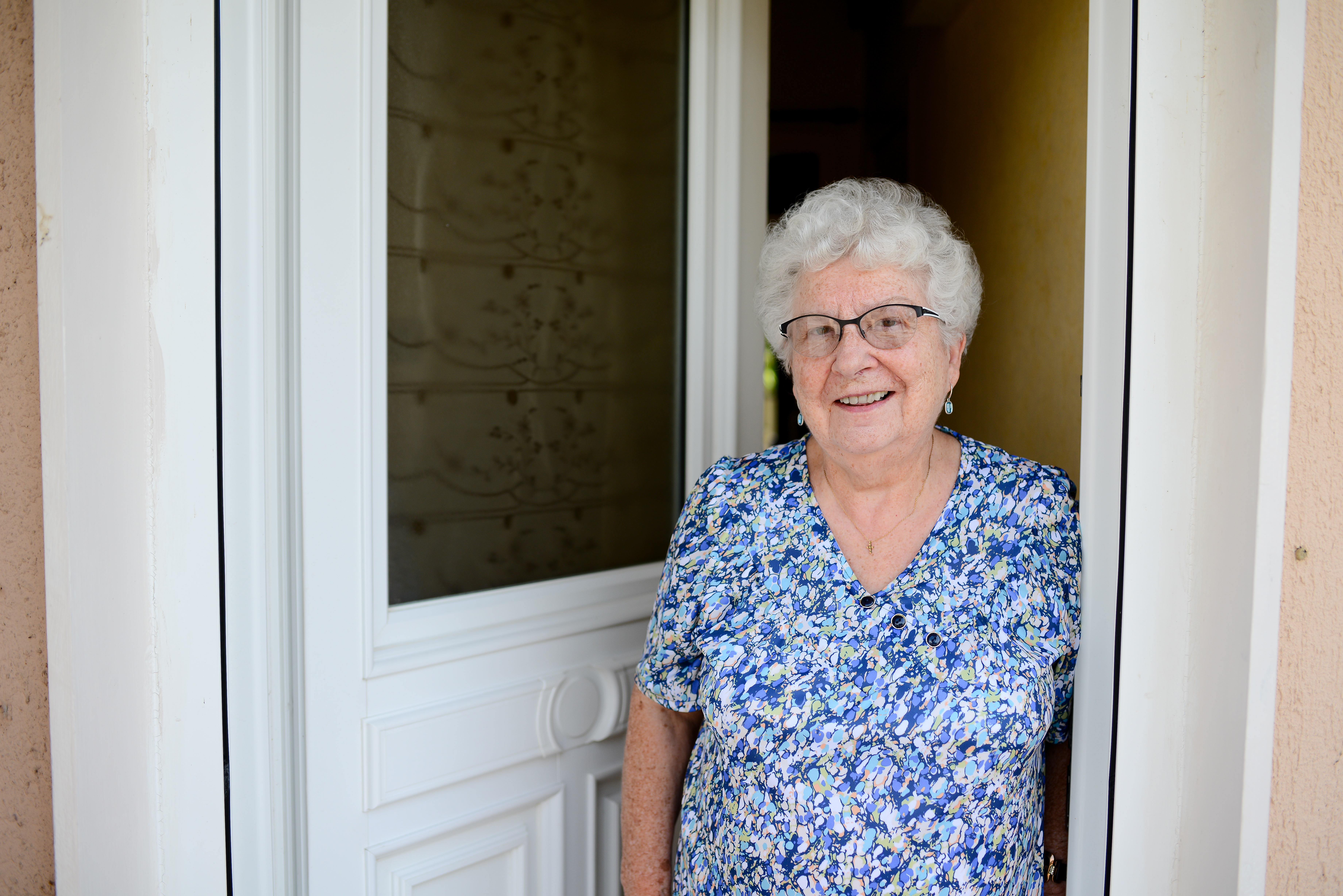 woman at front door smiling 