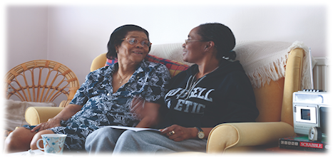 Couple sat on a sofa enjoying a befriending session