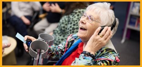 Woman wearing headphones and smiling