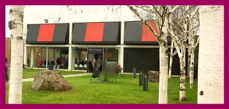 Tilly's coffee cafe building front with grass and trees outside