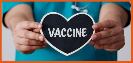 doctor holding vaccine sign