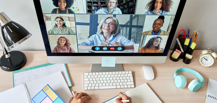 Person using computer with other people on the screen